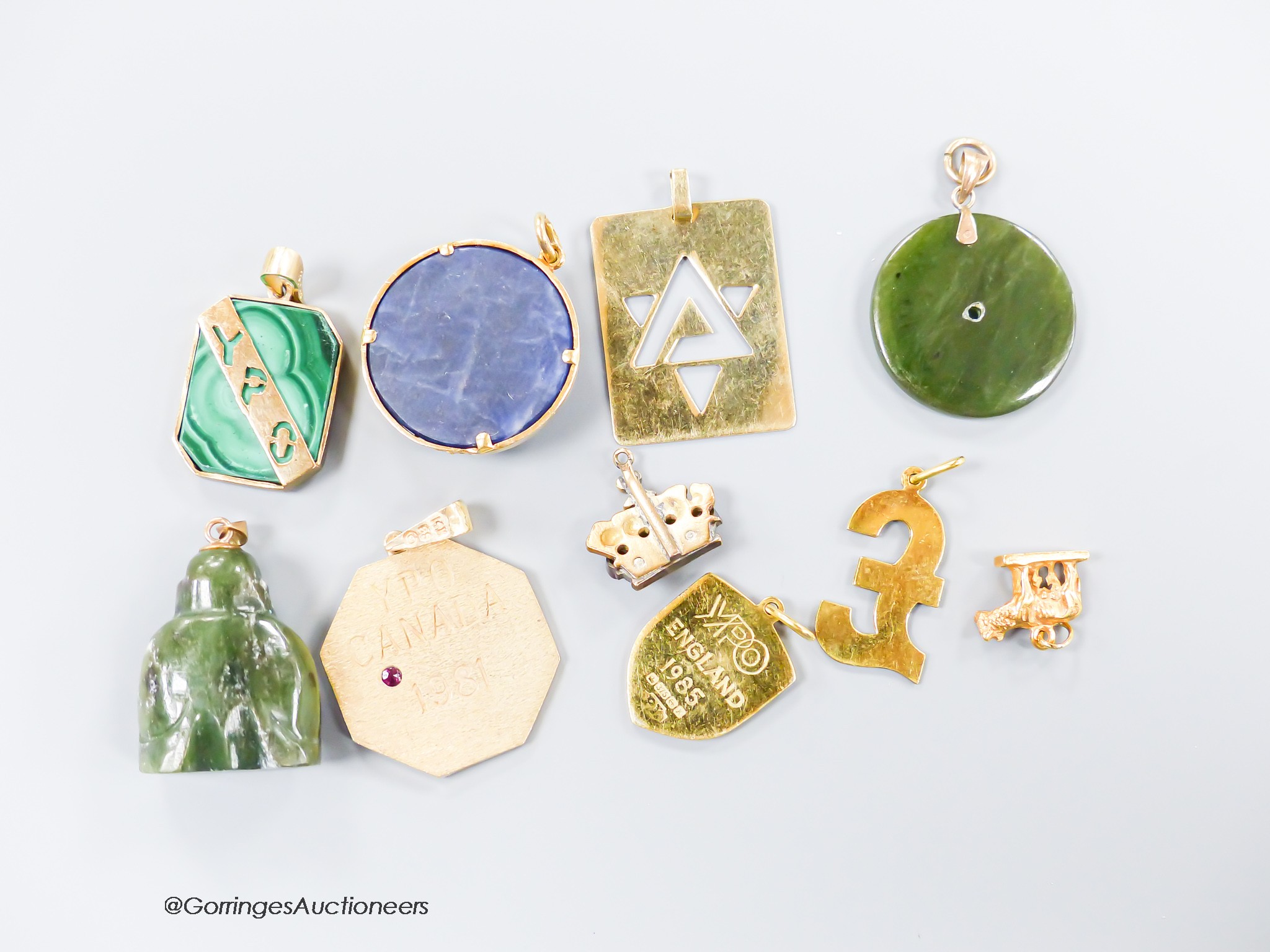 A small collection of ten assorted mainly yellow metal and gem set pendants including a red enamel and diamond set coronet pendant 15mm and an 18k mounted nephrite pendant, one other stamped 14k, 7.4 grams and a 9ct and